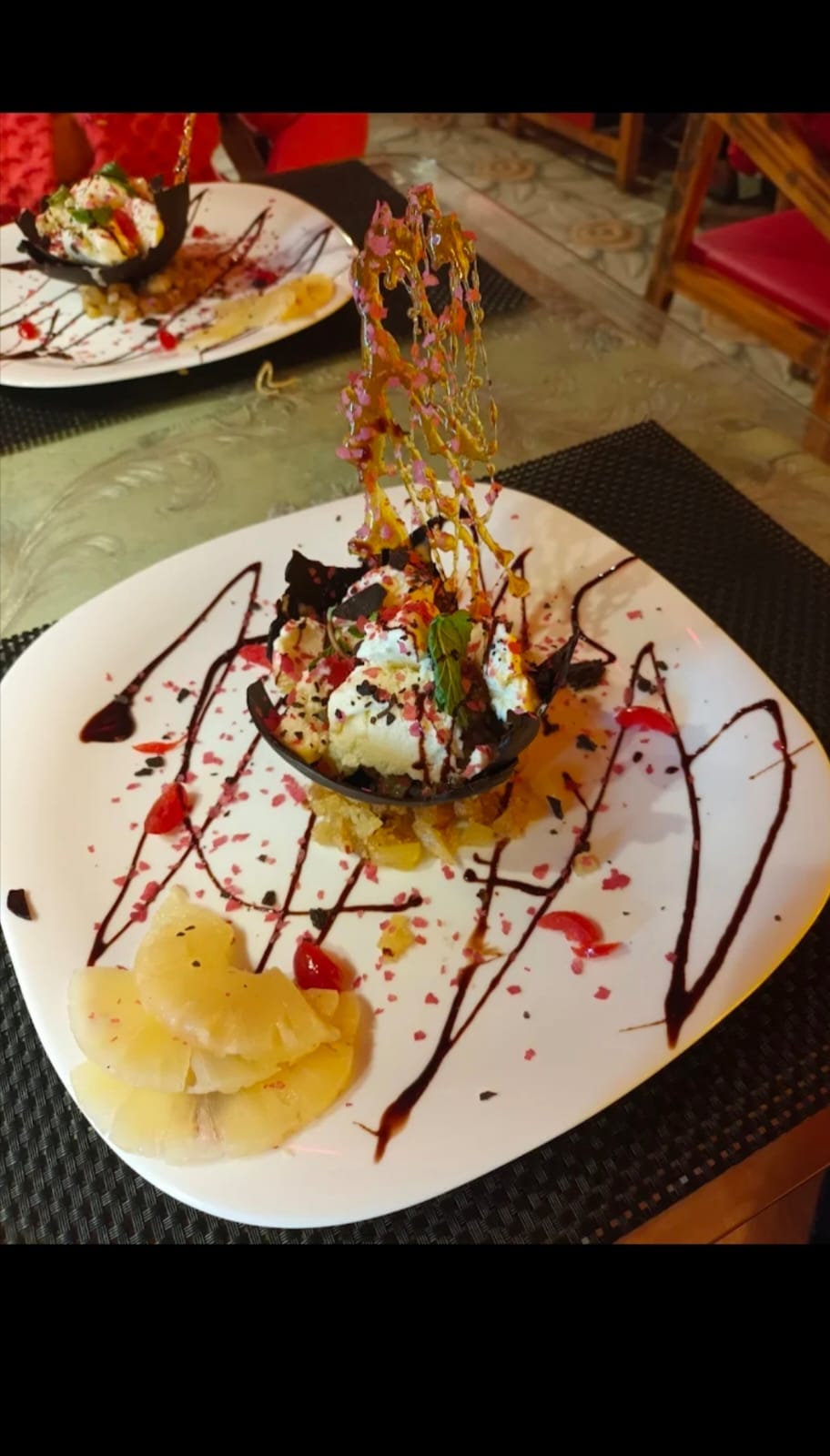 Plated dessert with caramel lattice and ice cream